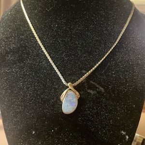 Opal set in 14K yellow gold with accent diamond and 18 inch chain.